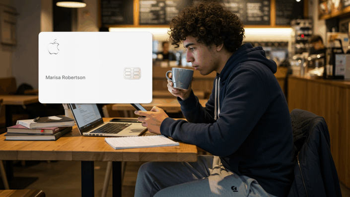 Young man with curly hair drinking a hot beverage in a café while using his mobile phone. A laptop and books are on the table. Overlaid on the image is a white Apple Card with the name Marisa Robertson.
