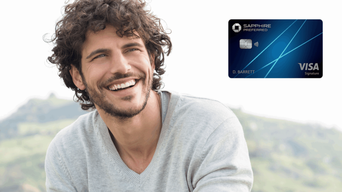 Advertisement featuring a smiling man next to the Chase Sapphire Preferred Credit Card, showcasing its blue design and key features.
